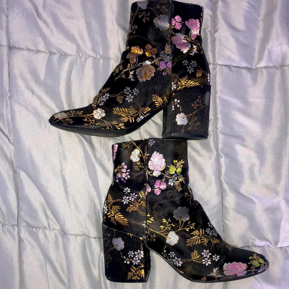 Black heeled booties with floral decal